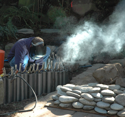 Employee working with welding equipment on jobsite
